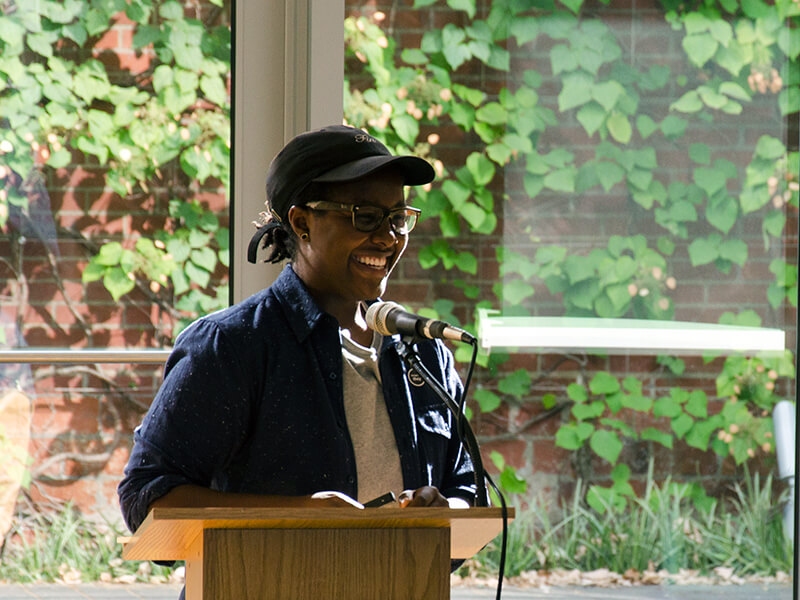 Photo of Morgen Bromell at a podium with a built-in mic